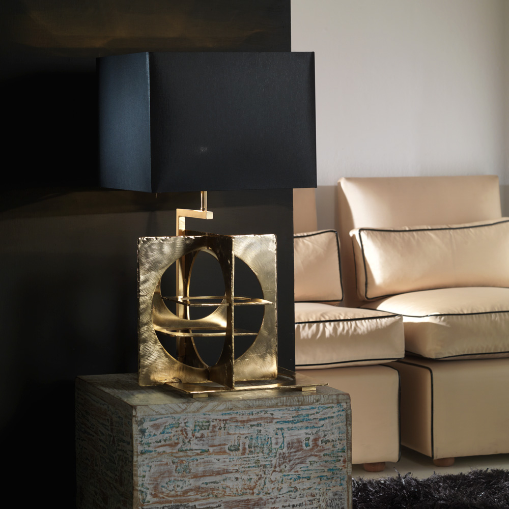 Table lamp in hand emery and engraved steel, aged gold finish. Black
chintz lampshade with golden inside.